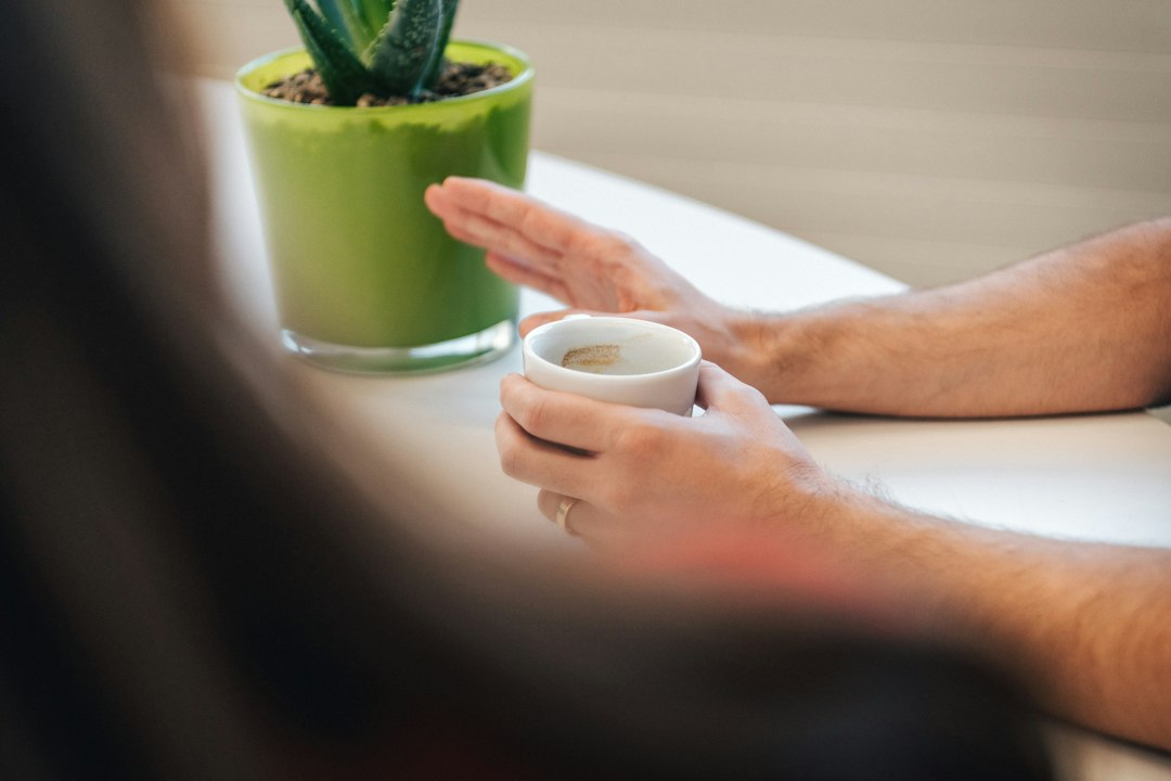 Person holding a warm cup during a quiet reflective moment